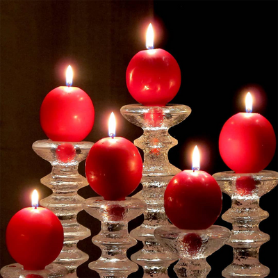 Lit Finnish Red Footed Ball Candles in Festivo candlesticks