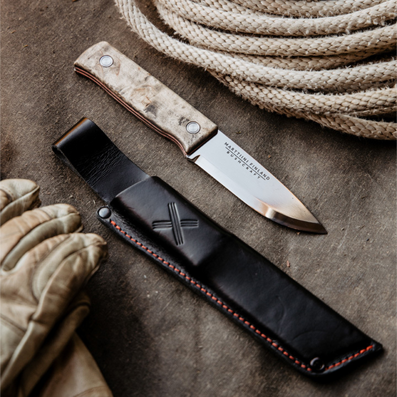 Marttiini Tundra GR Knife with sheath on display next to work equipment