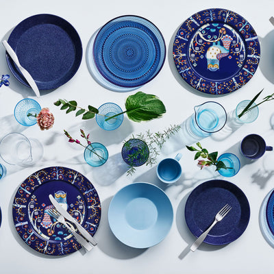 Display on white table of blue color dinnerware