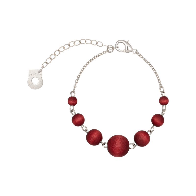 Bracelet with red beads and silver chain on a white background