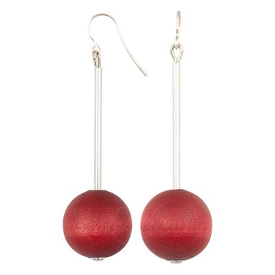 Red spherical earrings on a white background
