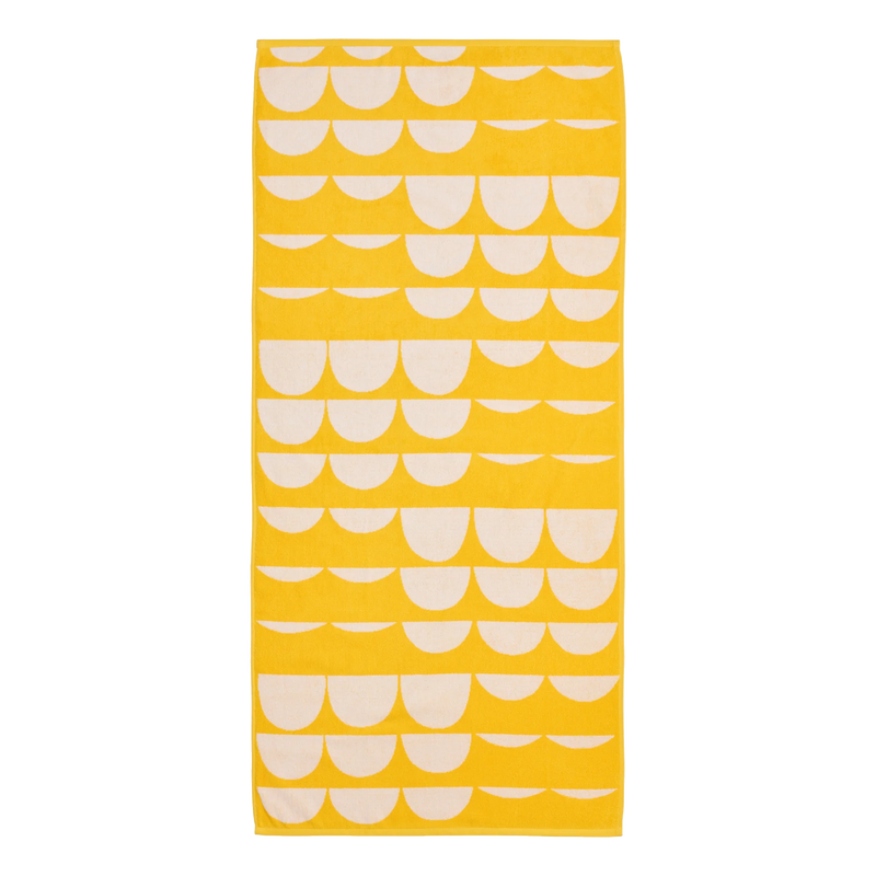 Yellow towel with white scalloped pattern on a white background