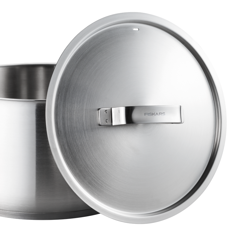 Stainless steel pot with lid featuring Fiskars branding on a white background