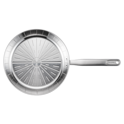 Stainless steel frying pan with a textured bottom on a white background