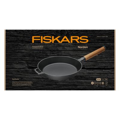 Fiskars Norden frying pan on a black wooden background