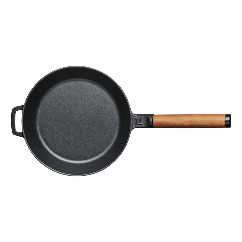 Black frying pan with a wooden handle on a white background