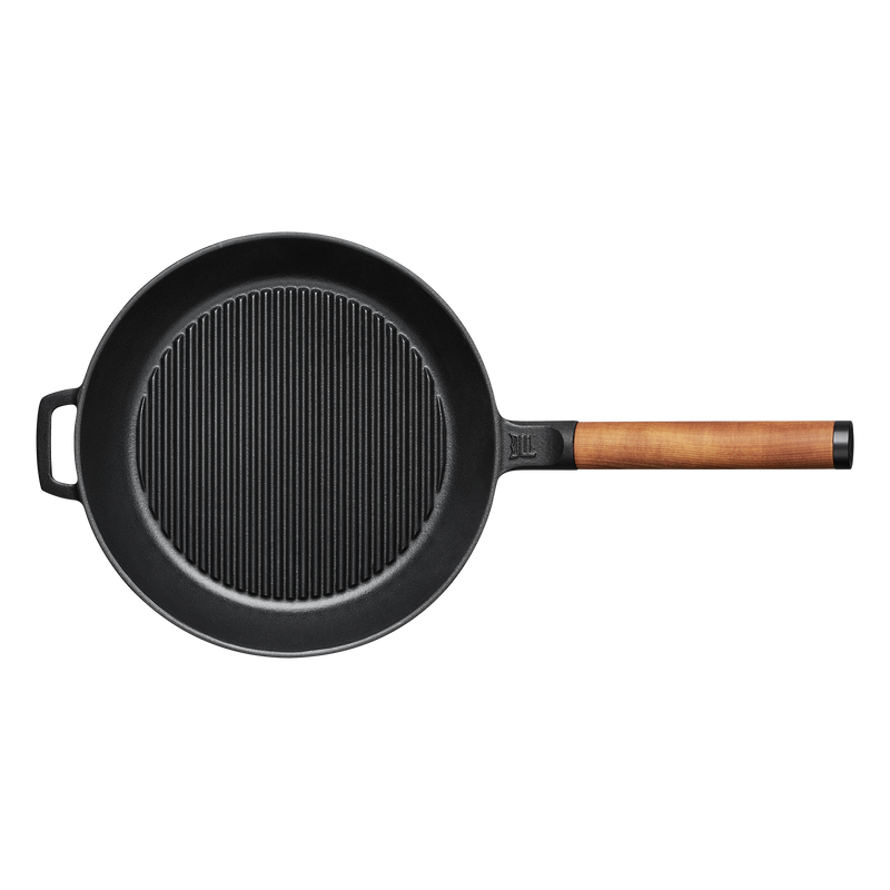 Black cast iron skillet with a wooden handle on a white background