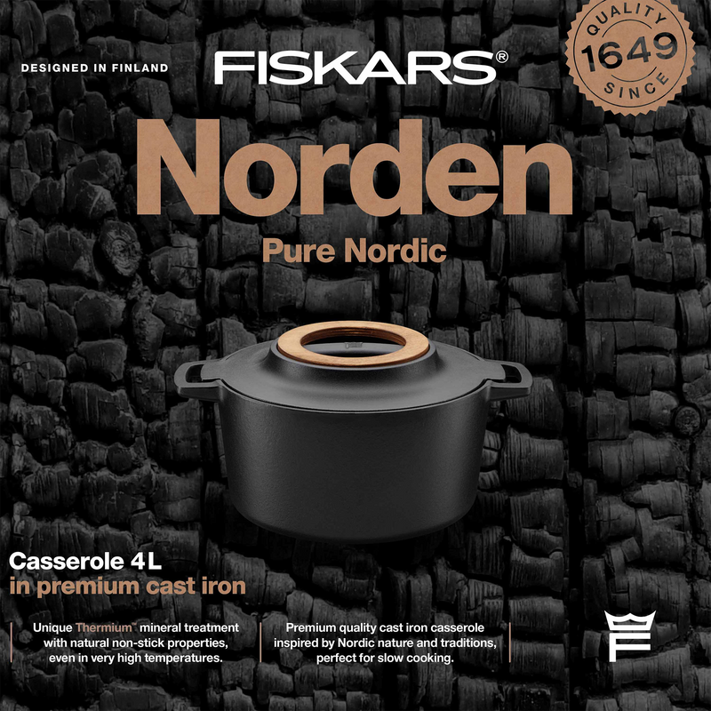 Fiskars Norden casserole dish with wooden handle on a textured black background