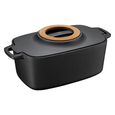 Black rectangular baking dish with a wooden lid on a white background