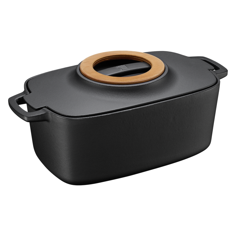 Black rectangular baking dish with a wooden lid on a white background