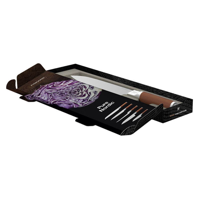 Set of knives with a decorative towel in an open black box on a white background