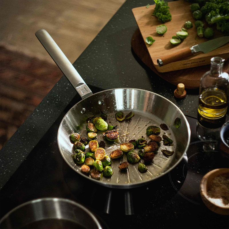 Frying pan with roasted vegetables on a kitchen counter