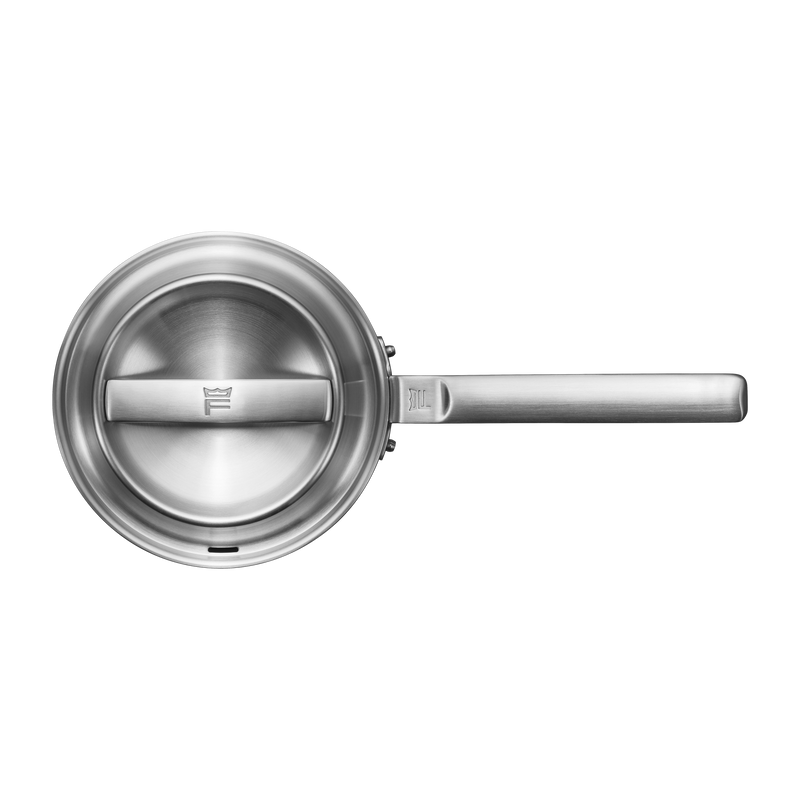 Stainless steel frying pan on a white background