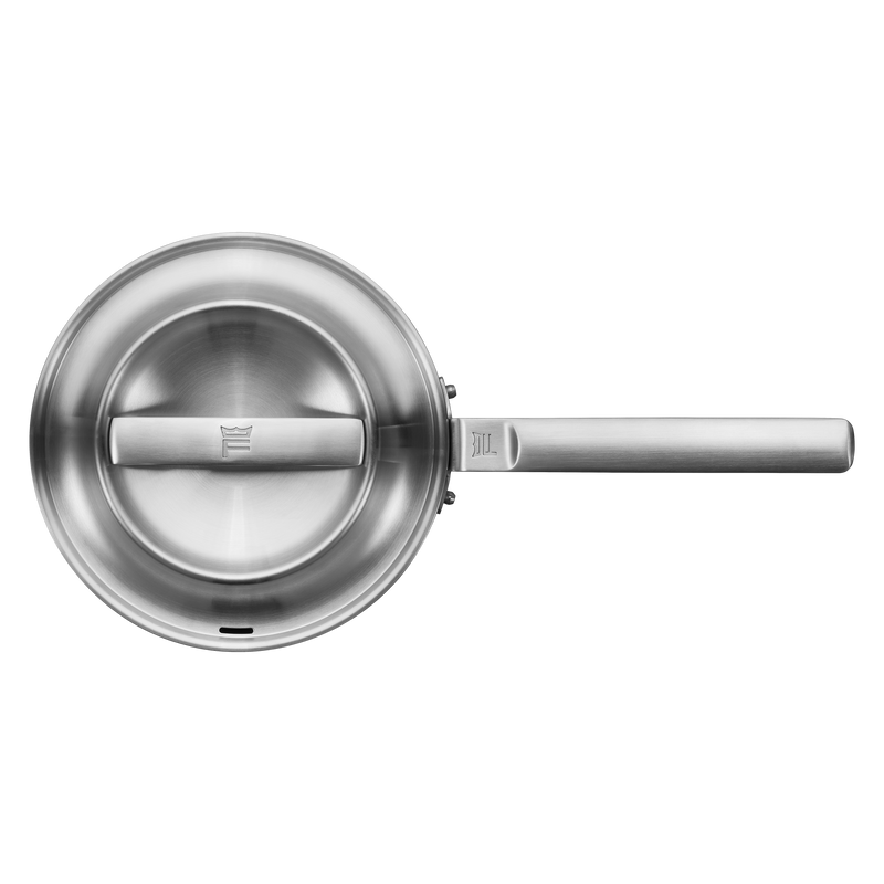 Stainless steel frying pan on a white background