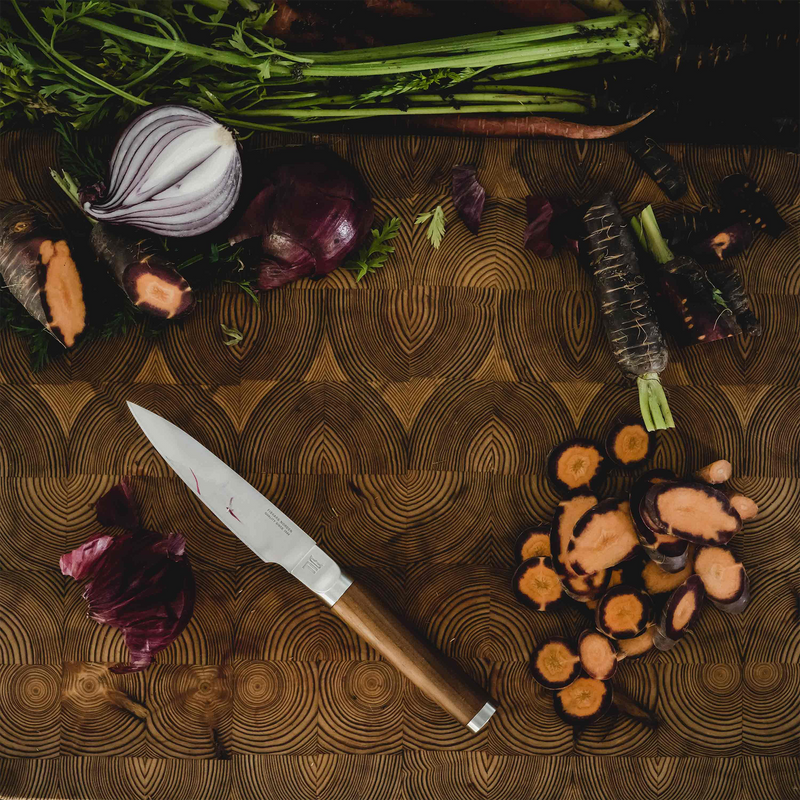 Vegetables and a knife on a wooden cutting board