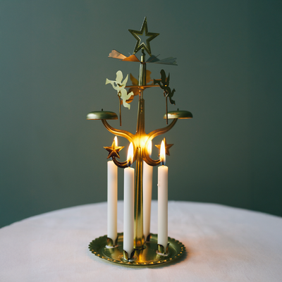 Decorative candle holder with candles on a dark green background