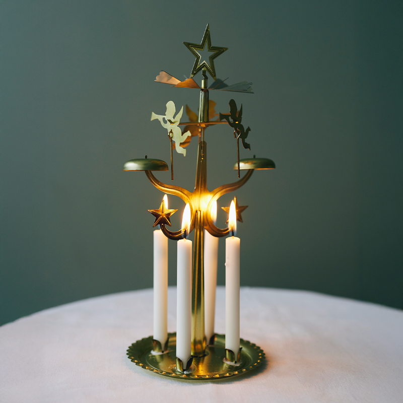 Decorative candle holder with candles on a dark green background