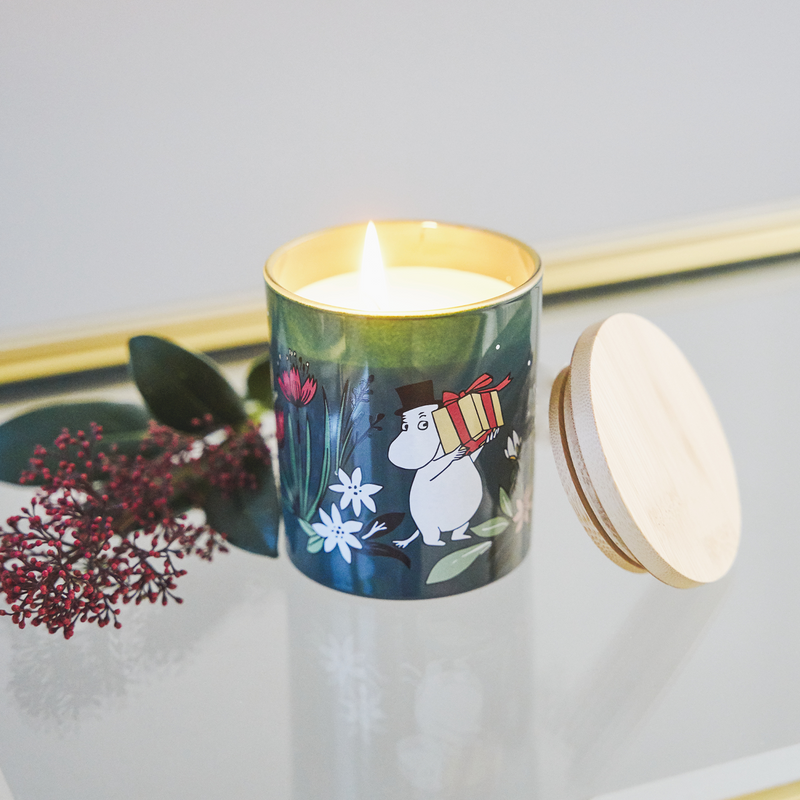 Candle in a decorative container with a cartoon character on a light gray background