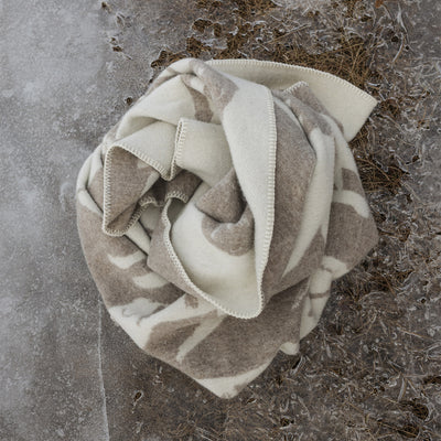Folded blanket with a geometric pattern on a frosty ground