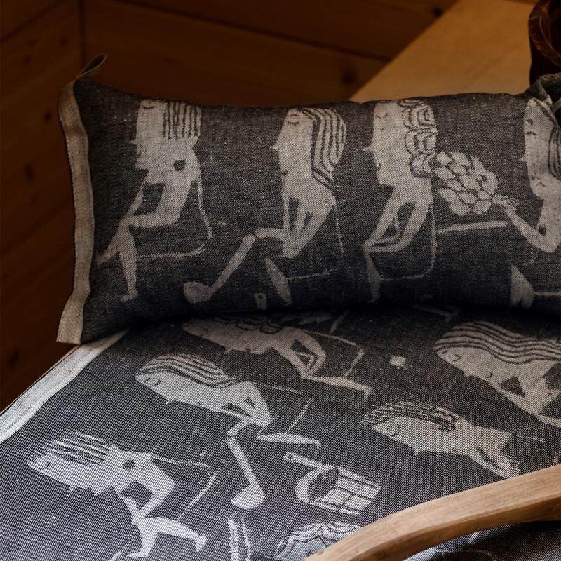 Decorative pillow with musical instrument pattern on a wooden chair