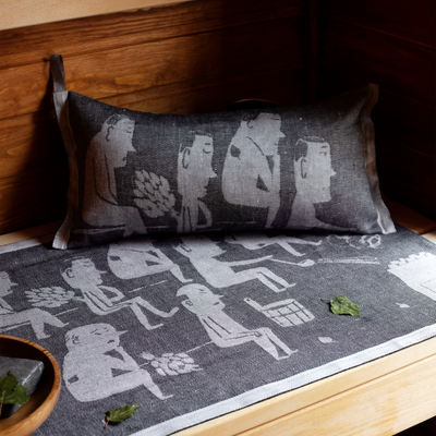 Gray cushion with illustrations of people on a wooden surface