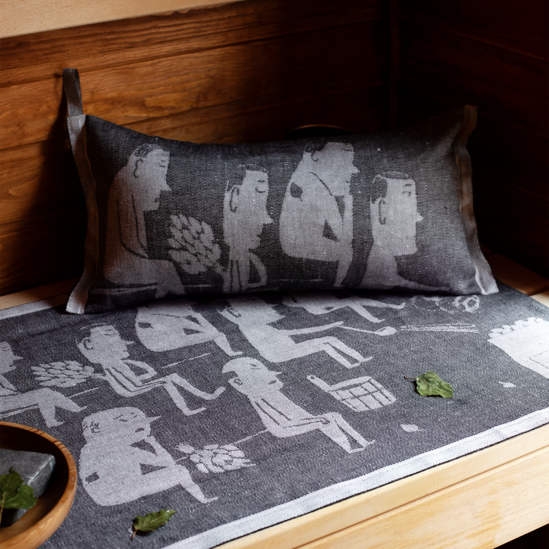 Gray cushion with illustrations of people on a wooden surface