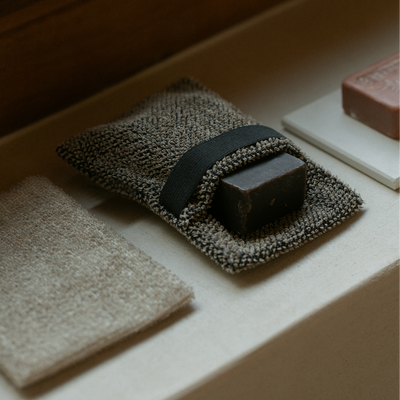 Bar of soap on a textured towel with a wooden background