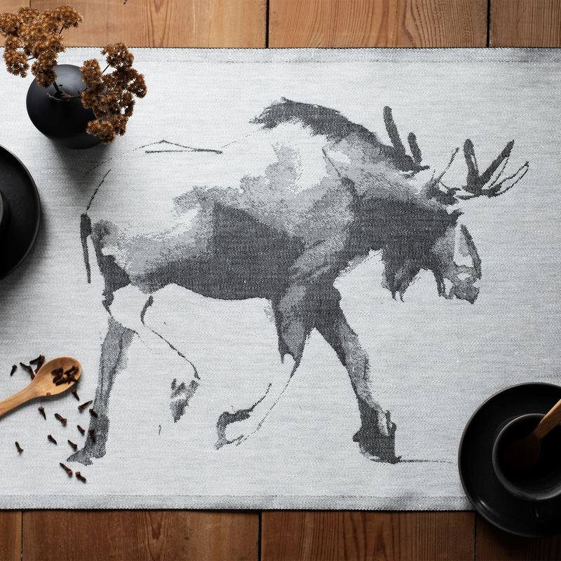 Placemat with moose design on a wooden table