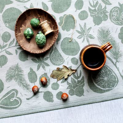 Ceramic cup and decorative items on a patterned surface