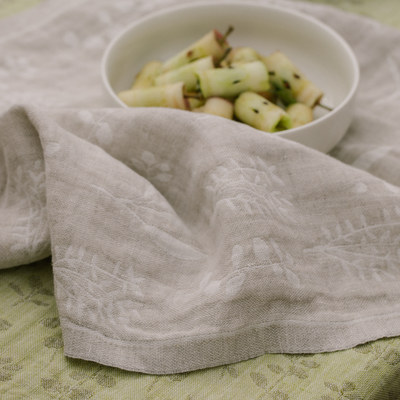 White bowl with fruit salad on a textured gray cloth