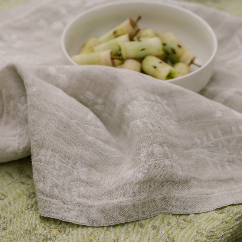 White bowl with fruit salad on a textured gray cloth