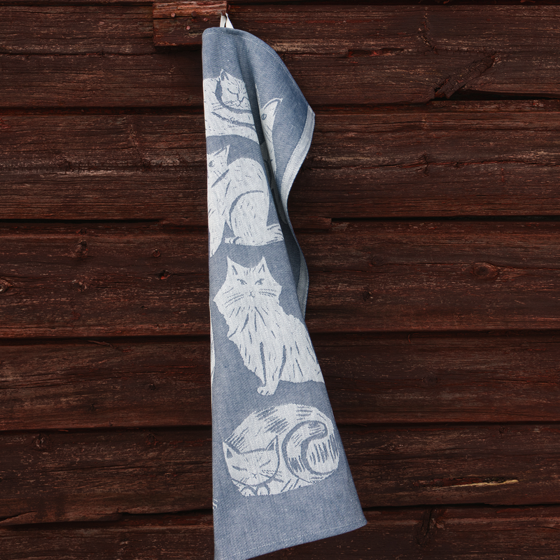 Gray towel with cat pattern hanging on a wooden surface