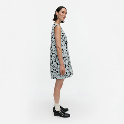 Woman wearing a black and white floral dress on a white background