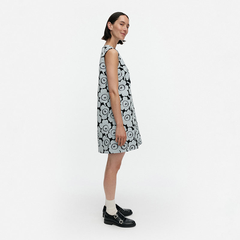 Woman wearing a black and white floral dress on a white background