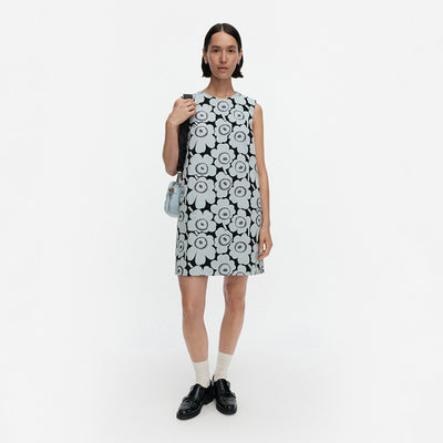 Woman wearing a black and white floral dress on a white background