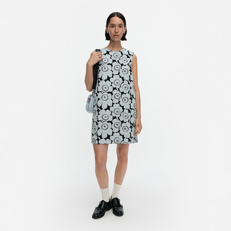 Woman wearing a black and white floral dress on a white background