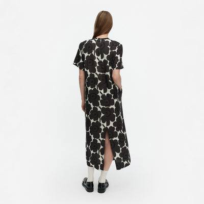 Woman wearing a black floral dress on a white background