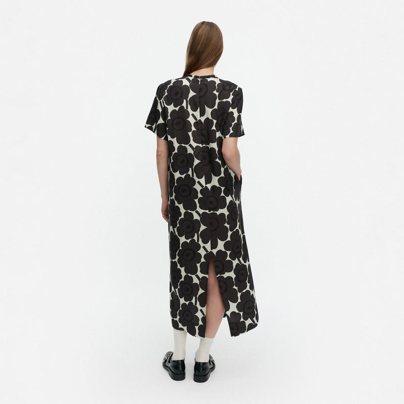 Woman wearing a black floral dress on a white background