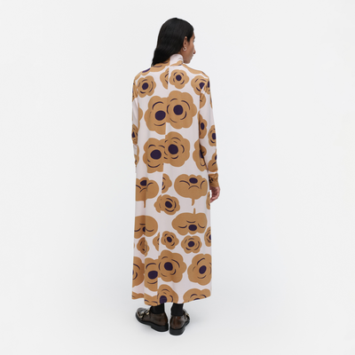 Person wearing a long floral dress on a white background