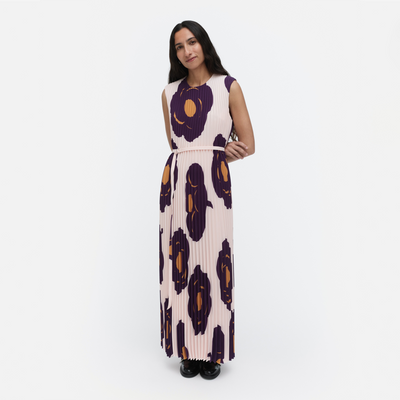 Woman wearing a long dress with a pattern on a white background