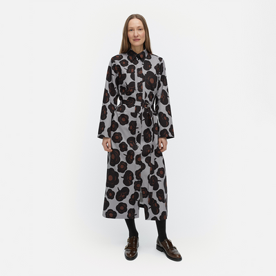 Woman wearing a patterned dress on a white background