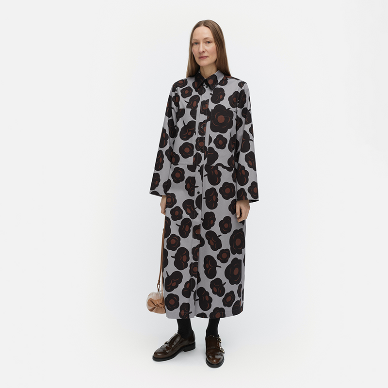 Woman wearing a long floral dress on a white background