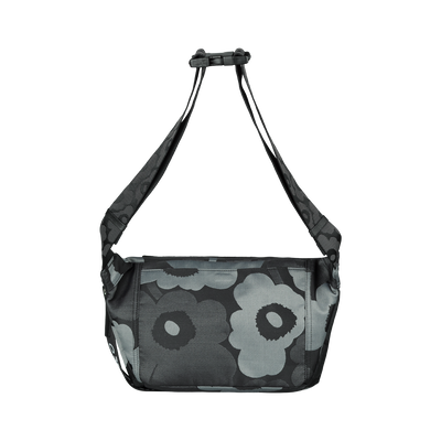 Floral patterned bag with a black strap on a white background