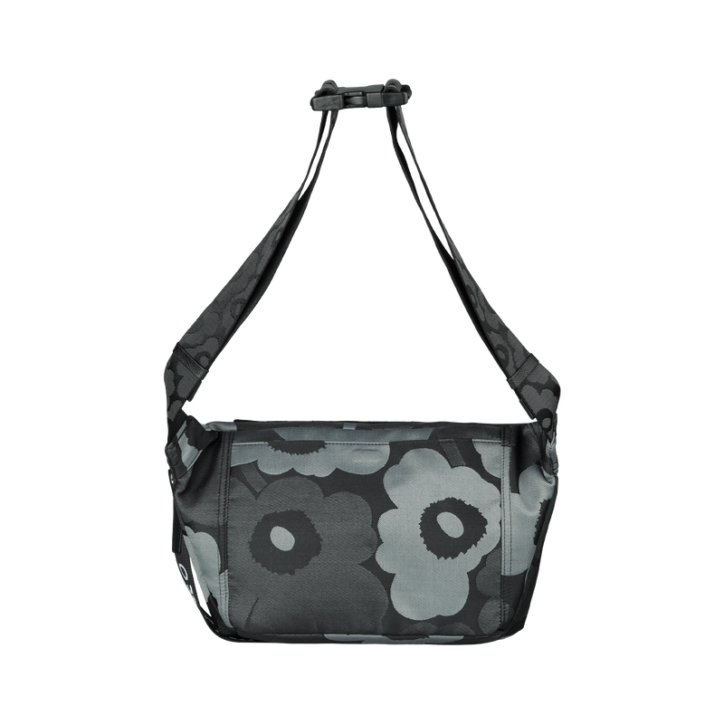 Floral patterned bag with a black strap on a white background