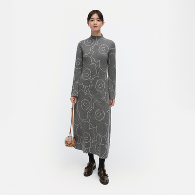 Woman wearing a gray floral-patterned dress on a white background
