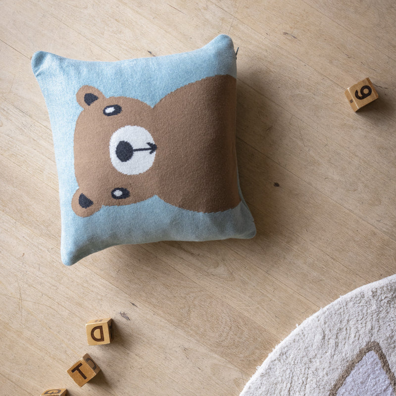 Cushion with bear design on a wooden floor