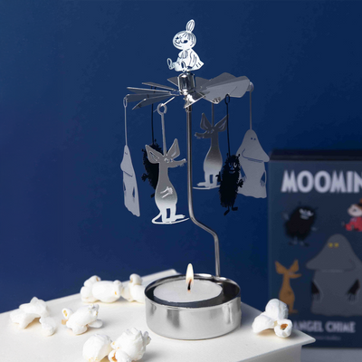 Decorative candle holder with cartoon characters on a blue background
