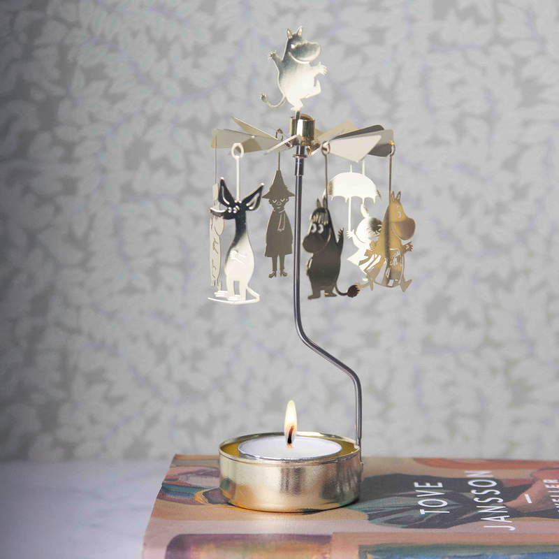 Decorative lamp with cartoon characters on a candle holder against a patterned wall.