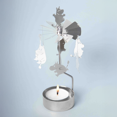 Decorative metal mobile with animals on a tealight holder against a light blue background