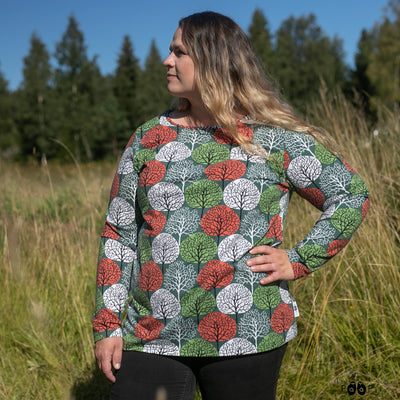 Woman in grassy field wearing Seasons Aava Shirt